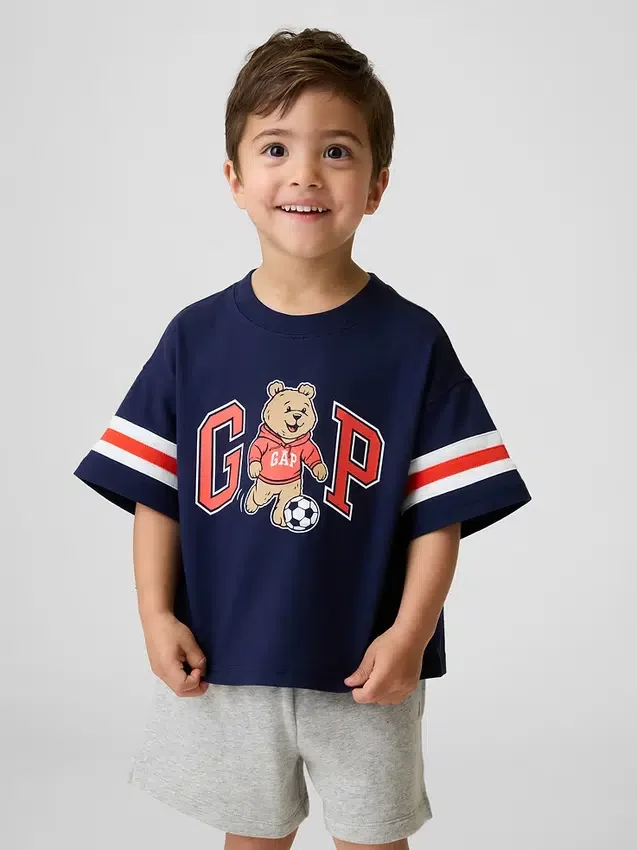 Μπλουζάκι με γραφικά και λογότυπο Brannan Bear Varsity σε oversized γραμμή για Βρέφη & Νήπια